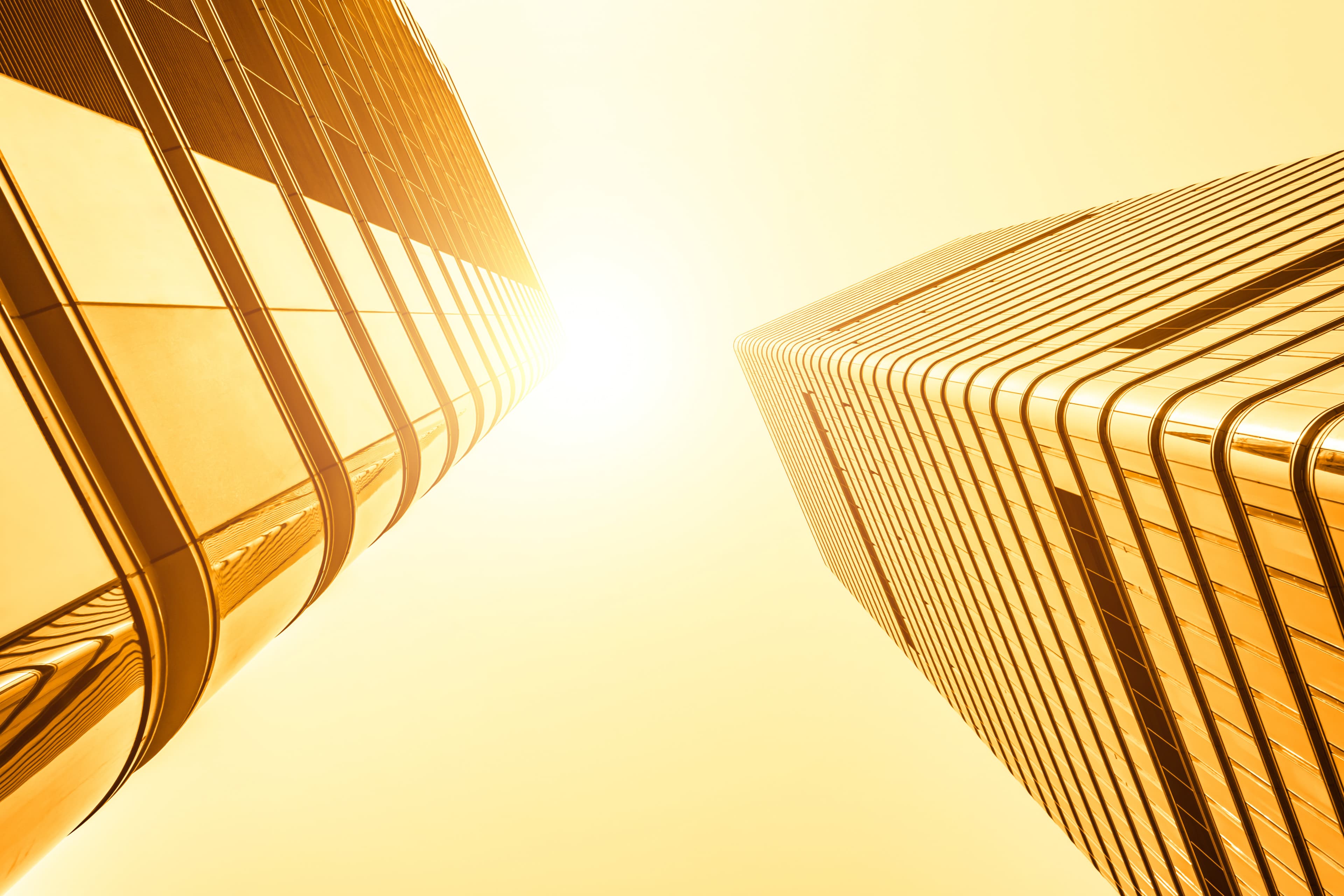 Two yellow buildings against a blue sky